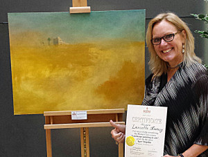 artist Laurette Kovary with her oil painting