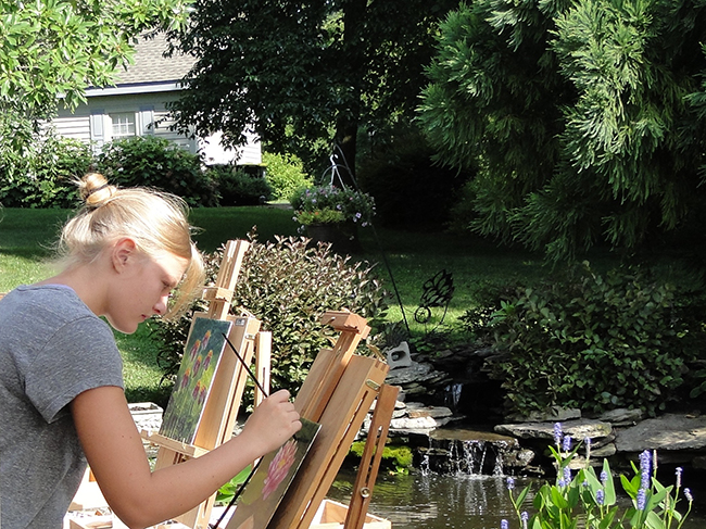 A focused Kyra at the easel